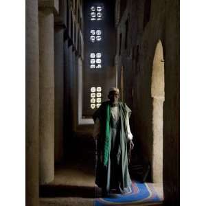 Imam of Kotaka Pauses Beside an Archway Inside the Impressive Mosque 