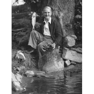  Senior Man Sitting By Water, Holding Up Fish Photographic 